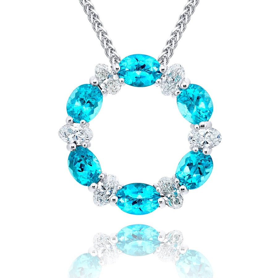 Exquisite Style: Our timeless Paraiba Circle Pendant. These stunning certified oval Paraibas cradled in oval diamonds are handcrafted in pure platinum.